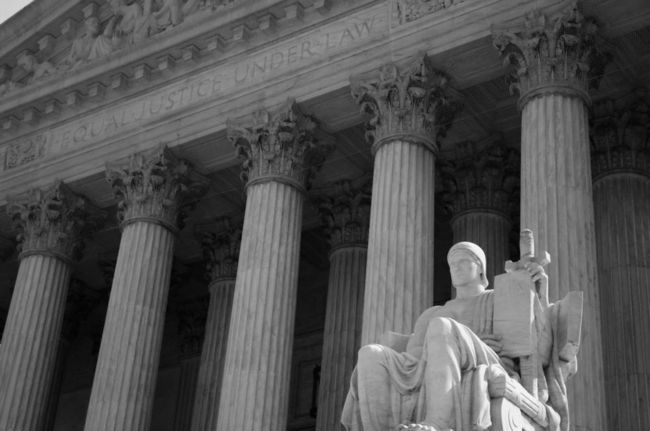 Another statue overlooking the steps of The Supreme Court