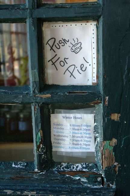 Ah, so this is where you go to get the goods! A worn doorway sign on the front door.