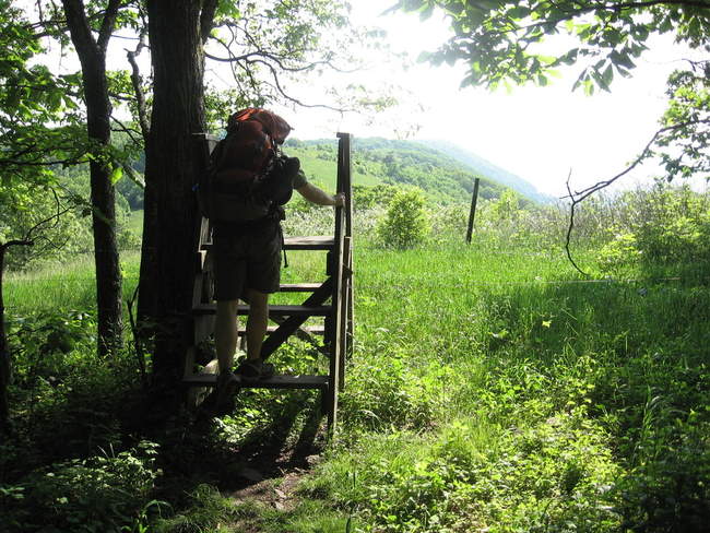 Scott climbing over an obstacle that leads to the saddle