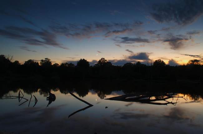 Mirrored moonrise over Claude Moore Park