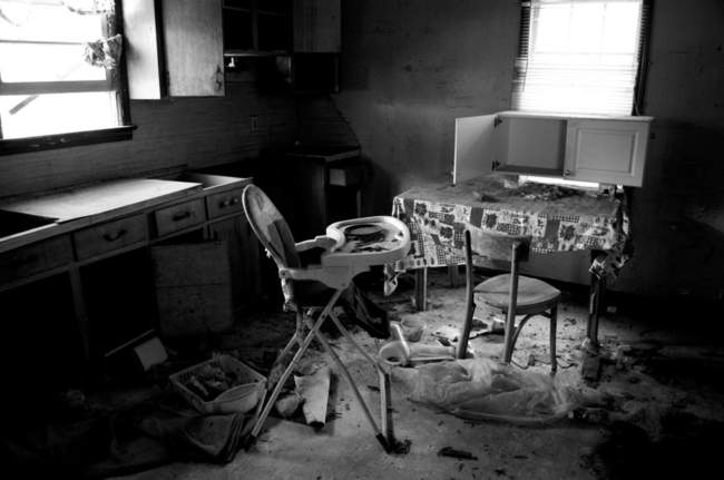 A high chair and some decaying plates