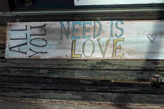 Weathered sign outside one of the shops.