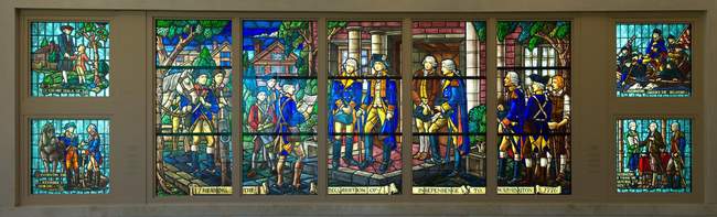 Awesome stained glass of some historical scenes in his life.