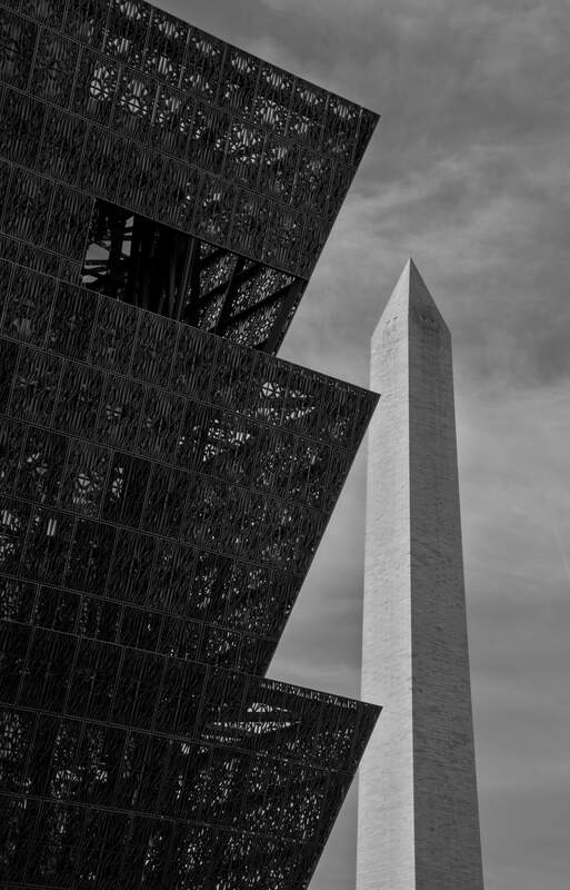 The museum stands in contrast to the Washington Monument behind